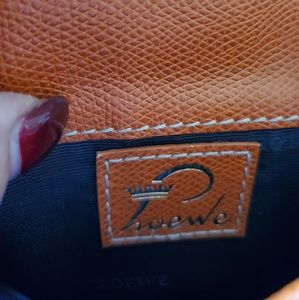 A mini Loewe bag with long leather strap .